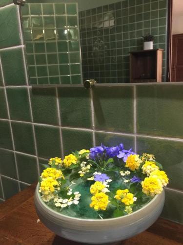 a toilet bowl filled with flowers in a bathroom at Billion Views Khaosok Homestay in Khao Sok