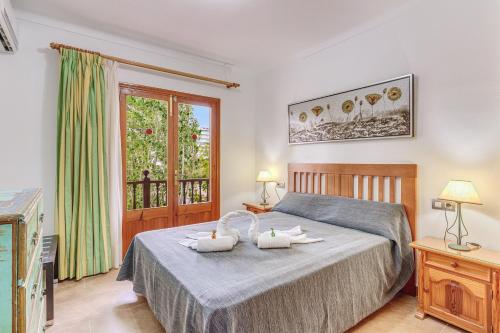 a bedroom with a bed with two towels on it at Villa Pintor in Port de Pollensa