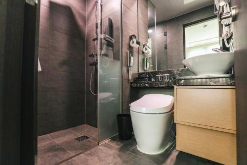 a bathroom with a toilet and a sink and a shower at ON City Hotel in Cheonan