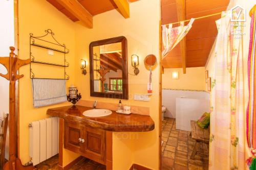 a bathroom with a sink and a mirror at Finca MARIPOSA Alcudia in Alcudia
