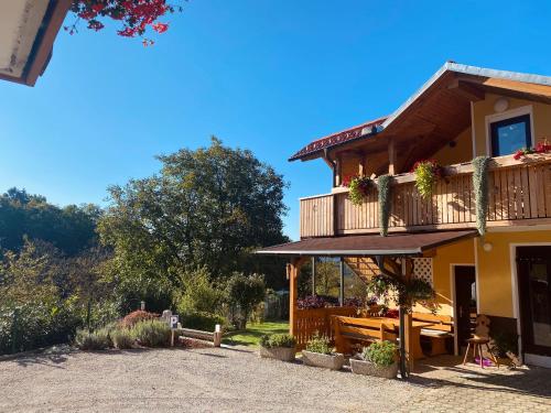 a house with a balcony and a patio at BeeWood apartment in Križe