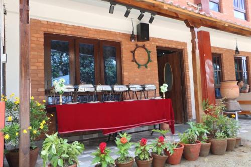 a building with a red table with chairs on it at Heritage Home Dhulikhel in Dhulikhel