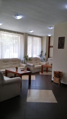 a living room with couches and a coffee table at Guest House Ela in Bansko