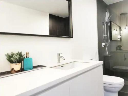 a bathroom with a sink and a toilet and a mirror at The Hub SS2 - Studio Suite Room in Kuala Lumpur