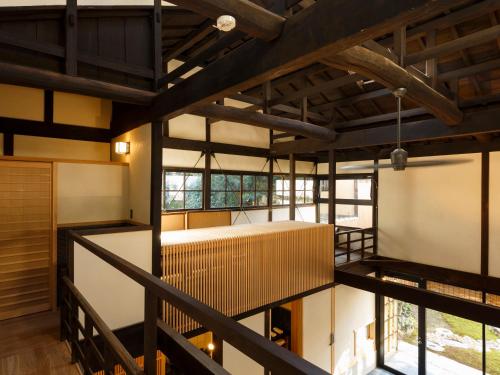 an interior view of a building with wooden beams at Tawara-an in Kyoto
