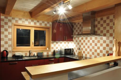 a kitchen with a sink and a counter top at Chalet Edelweiss Stunning Glacier View in Les Diablerets
