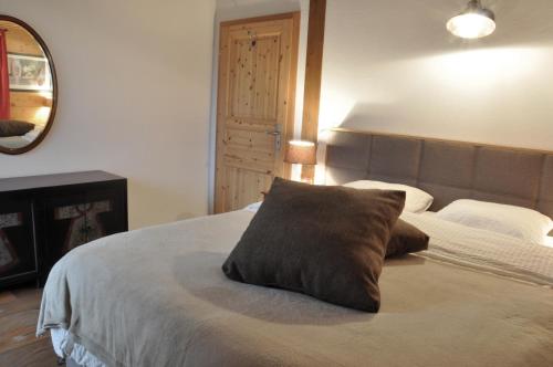 a bedroom with a bed with a pillow on it at Chalet Edelweiss Stunning Glacier View in Les Diablerets