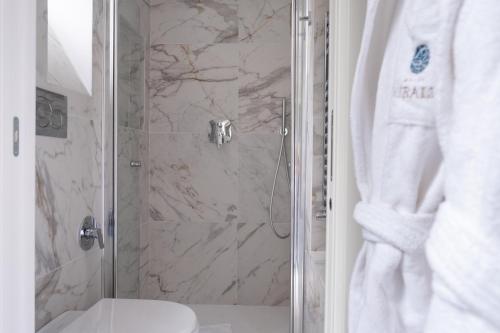 a bathroom with a shower with a toilet and a sink at Hotel Smeraldo in Rome