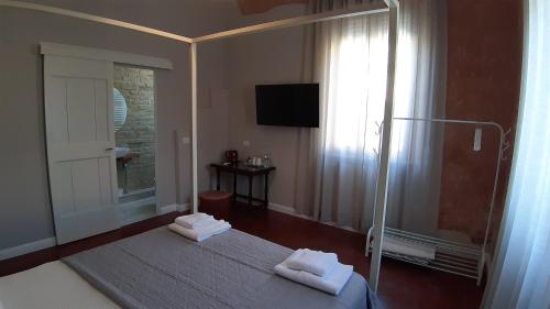 a bedroom with a bed with two towels on it at B&B Suite 44 in Pesaro