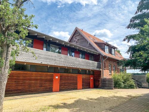 a large building with orange doors in front of it at PRIMA Inn Ferienwohnungen Sonnenufer am Ruppiner See in Neuruppin