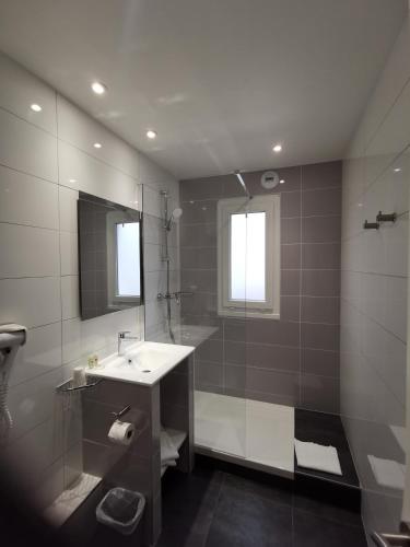 a bathroom with a sink and a shower at Atalante in Annemasse