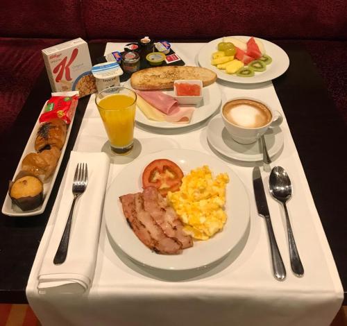 a breakfast tray with breakfast foods on a table at Hotel Boutique Gareus in Valladolid