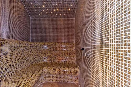 a large tiled bathroom with a tub in a room at Belvedere Holiday Club in Bansko