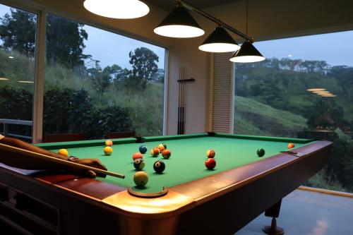 a pool table with balls on it in a room with a window at Skyloft Kandy by Aaradhya in Kandy
