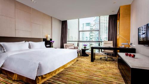 a hotel room with a large bed and a desk at Holiday Inn Nanchang Riverside by IHG in Nanchang