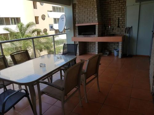 a dining room with a table and chairs and a fireplace at Margate, Granada 104 in Margate