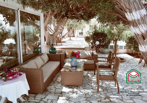 a patio with a couch and chairs and a table at Casa Mia in Ouled Kacem