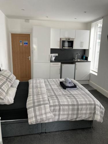 a bedroom with a bed with a hat on it at The Gladson Guesthouse in Cleethorpes