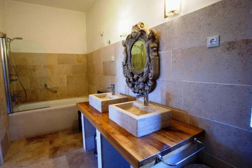 a bathroom with two sinks and a mirror and a tub at Villa Bazjaki - Beautiful stone villa in Istria with private pool in Livade