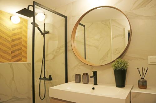 a bathroom with a sink and a mirror at Modern Cozy Apartment - NEW in Kyustendil