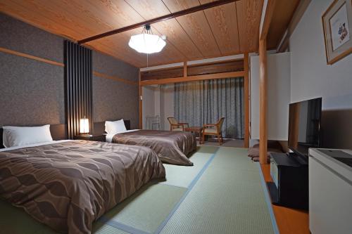 En eller flere senge i et værelse på The Gran Resort Ako