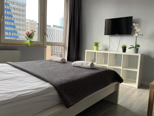 a bedroom with a bed and a television at Top Ten House Marszałkowska 8 in Warsaw