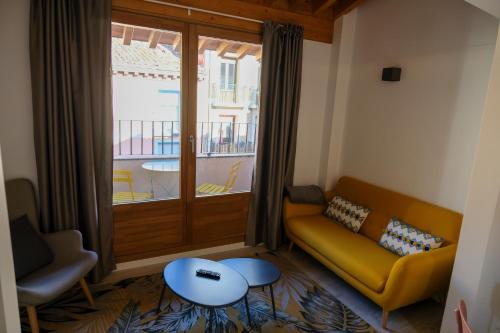 a living room with a couch and a window at Silken Casa Platerias Siglo XV in Zaragoza