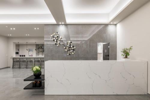 a lobby with a white counter and a kitchen at Melina Oasis Boutique Hotel in Kassiopi