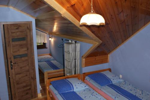 a room with three bunk beds in a house at Agrogosia in Czajowice