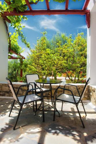 two chairs and a table on a patio at Hotel Charissi in Mýkonos City