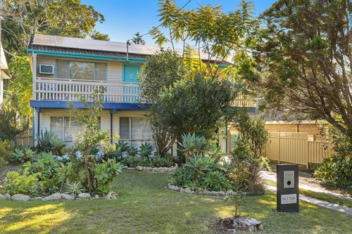 a house with a garden in front of it at Central Coast Escape in Point Clare