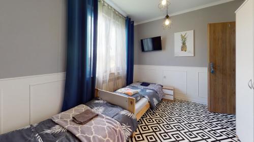 a bedroom with two twin beds and a window at Pokoje Hotelowe "Lila" Siedlce in Siedlce