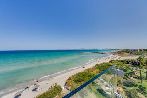 an aerial view of a beach with people in the water at Playa Esperanza Resort Affiliated by Meliá in Playa de Muro