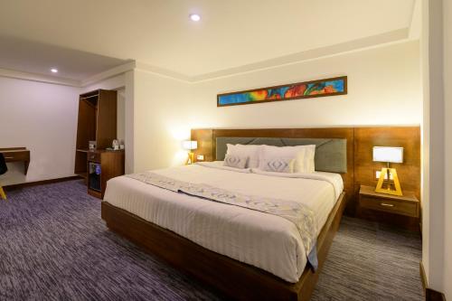 a hotel room with a large bed in it at Hotel Zakaria International in Dhaka