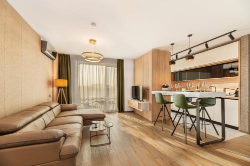 a living room and kitchen with a couch and a table at Promenada Studios in Braşov