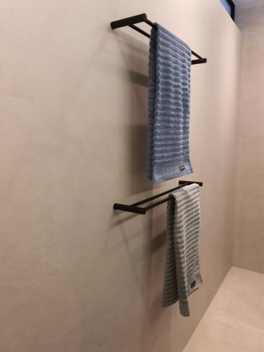 a bathroom with two towels hanging on a wall at B&B Doremi in Kaatsheuvel