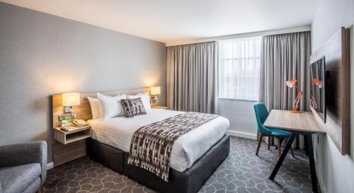 a hotel room with a bed and a desk at Holiday Inn Ellesmere Port/Cheshire Oaks by IHG in Ellesmere Port