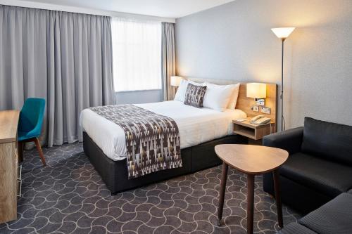 a hotel room with a bed and a couch at Holiday Inn Ellesmere Port/Cheshire Oaks by IHG in Ellesmere Port