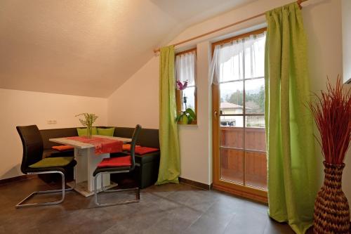 a dining room with a table and chairs and a window at Ferienwohnung Klingler in Scheffau am Wilden Kaiser