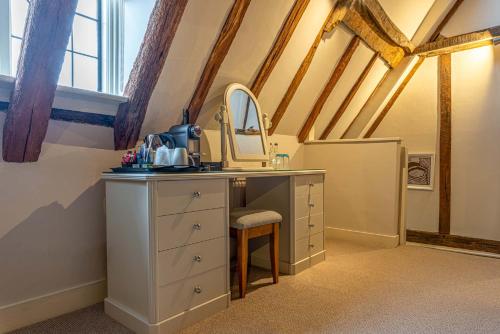 a bathroom with a sink and a mirror at The Sun Inn in Faversham