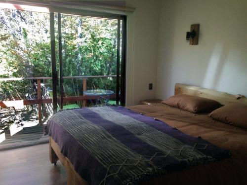 Tempat tidur dalam kamar di Refugio Ecobox Andino