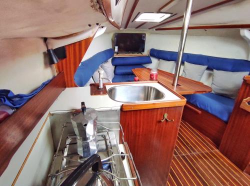 a kitchen in a boat with a sink at Voilier à quai au calme in Canet-en-Roussillon