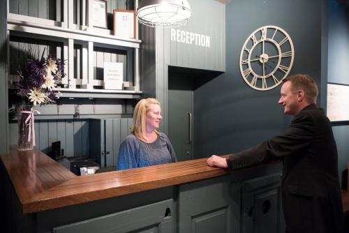 a man and a woman standing at a reception desk at The Ship & Trades in Chatham
