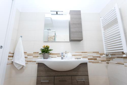 une salle de bain avec un lavabo et un miroir dans l'établissement Dreaming in Rome - Vittorio Veneto Guest House, à Rome