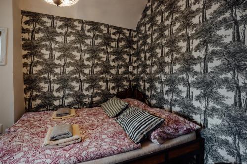 a bedroom with a bed with two towels on it at Strieborný dvor in Banská Štiavnica