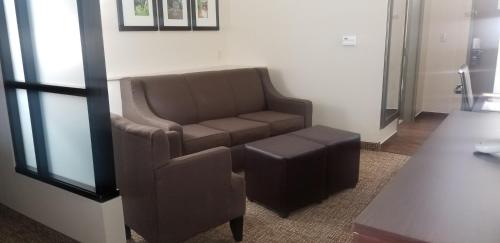 a living room with a couch and a chair at Comfort Suites Little Rock West in Little Rock