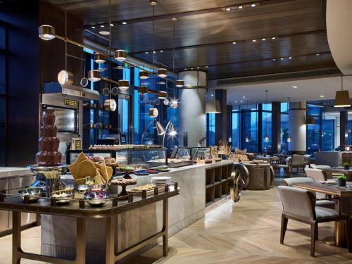 a restaurant with a buffet with tables and chairs at InterContinental Shanghai Wonderland by IHG in Songjiang