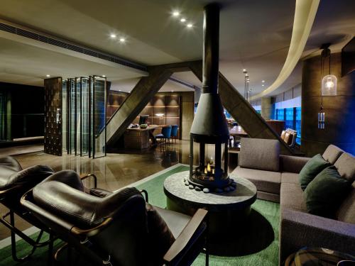 a living room with a couch and a table at InterContinental Shanghai Wonderland by IHG in Songjiang