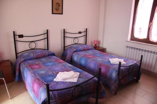 Posteľ alebo postele v izbe v ubytovaní B&B le margherite