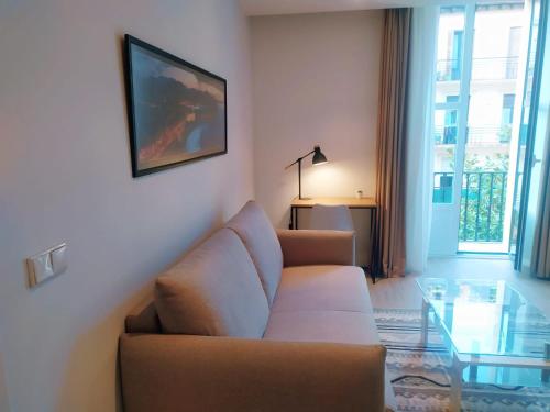 a living room with a couch and a glass table at Pensión Sarriegi in Donostia-San Sebastián